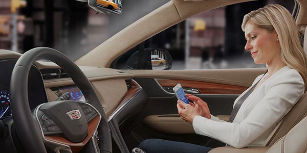 Woman driving a Cadillac vehicle